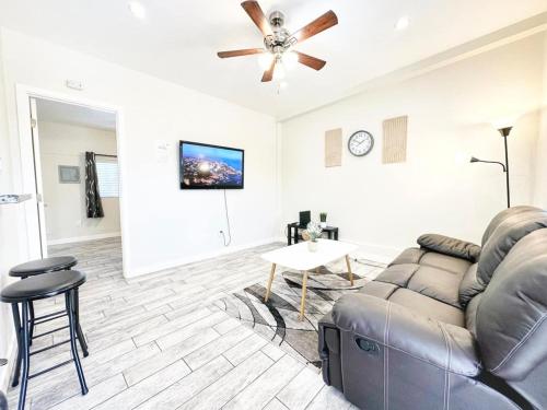 a living room with a couch and a ceiling fan at Modern Retreat Just Outside The City in San Diego