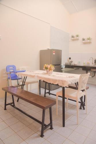 a dining room with a table and chairs in a kitchen at The Karaoke Homes Ipoh, Oldtown in Ipoh