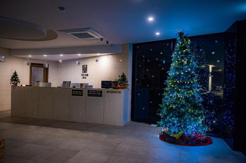 a christmas tree in a room with a christmas at The Van Hotel in Ulsan