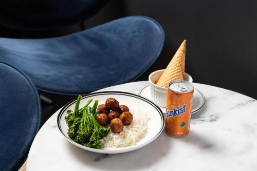 a table with a bowl of rice and a bowl of food at Crowne Plaza Canberra by IHG in Canberra