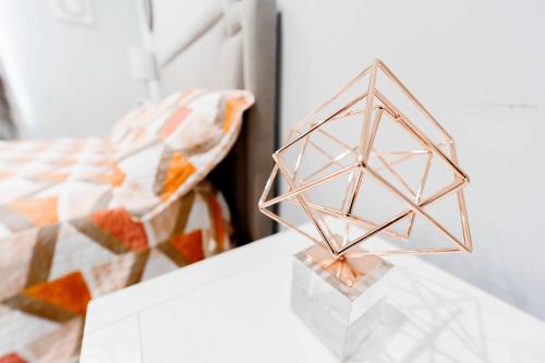 a metal object on a table next to a bed at The Nesting Gem in Orangetree