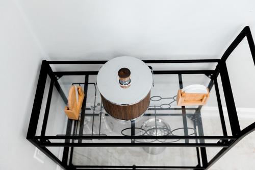a round mirror in a room with a sink at The Nesting Gem in Orangetree