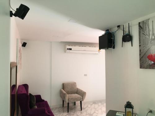 a living room with two chairs and a tv at เดอะวิลล่า71 รีสอร์ท in Ban Zong Katiam