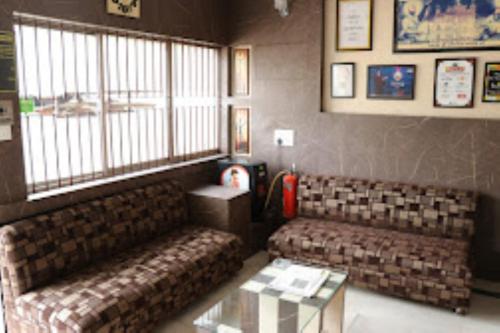 uma sala de estar com dois sofás e uma mesa em Hotel Prince B Guwahati em Guwahati