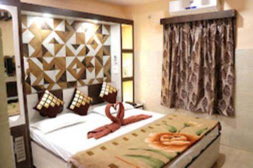 a bedroom with a large bed with a snake on it at Hotel Prince B Guwahati in Guwahati