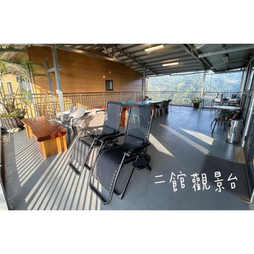 a balcony with chairs and tables in a building at 星森林包棟住宿-台中東勢-山區景觀 in Dongshi