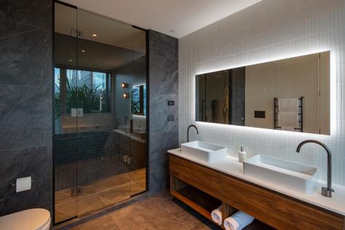 a bathroom with two sinks and a large mirror at Amaroo in Queenstown