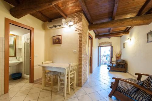 a kitchen with a table and chairs in a room at Bed And Breakfast Mblò in Fondi