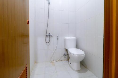 a bathroom with a toilet and a shower at Limo Depok Residence RedPartner in Depok