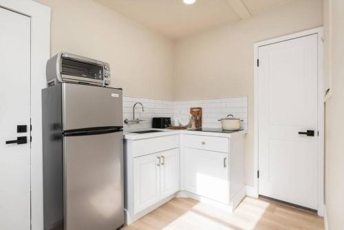 a kitchen with white cabinets and a refrigerator at Downtown Lodi l Renovated l 5 Bedrooms l Sleeps 10 in Lodi