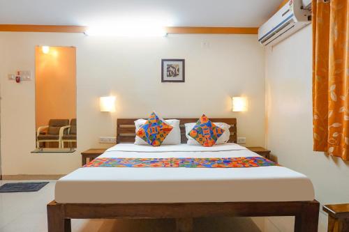 a bedroom with a large bed with two pillows at FabHotel Prime Vishwakirti Agri in Ahmadnagar
