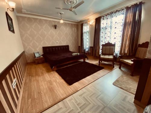 a living room with a couch and a chair at Shalimar Heights in Srinagar