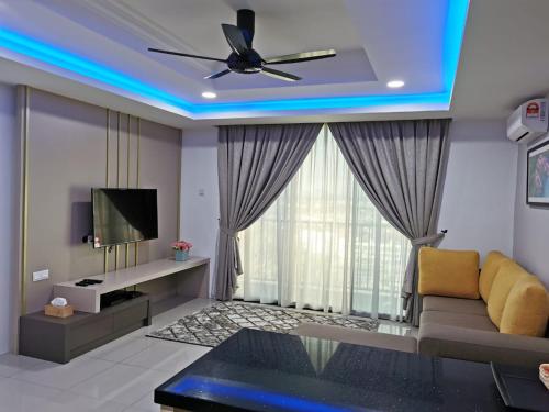 a living room with a ceiling fan and a tv at Eijaz Homestay @ Casa Kayangan in Ipoh