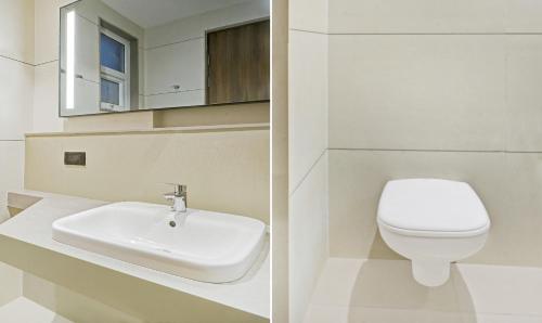 a bathroom with a white toilet and a sink at Treebo Premium La Orchid, Big Temple in Thanjāvūr
