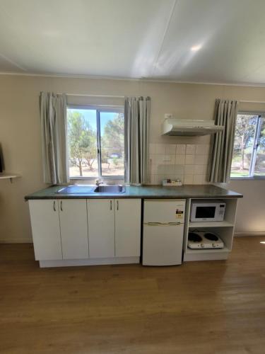 a kitchen with a counter and a sink in a room at Mt Barker Holiday Park - Western Australia in Mount Barker