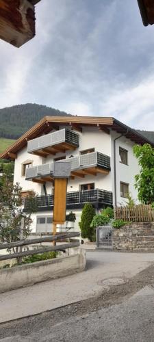 a white building with balconies on the side of it at Haus Stecher in Nauders