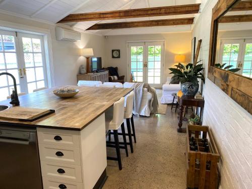 a kitchen with a counter and a living room at The Edward Townhouse 151 - Tastefully Styled in Orange