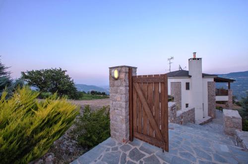a wooden gate in front of a house at Guesthouse Diochri in Kato Trikala Korinthias