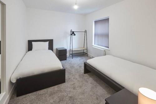 a bedroom with two beds and a window at Zetland House Apartment 1 Loftus in Loftus