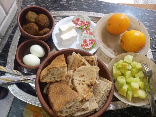 a tray of food with eggs and bread and fruit at Nubian Bride guest house in Aswan