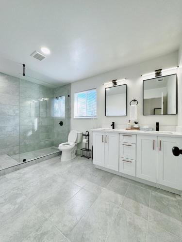 a bathroom with a shower and a toilet and a sink at Trendy Trenholm in Elk Grove