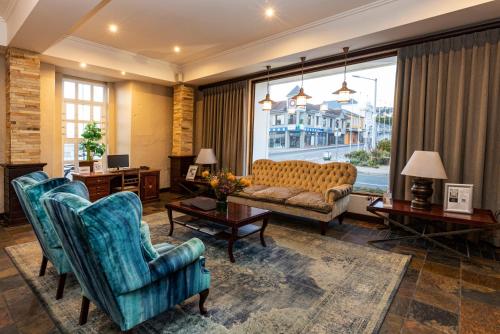 a living room with a couch and two chairs at Protea Hotel by Marriott Mossel Bay in Mossel Bay