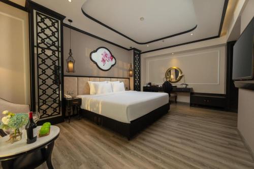 a hotel room with a bed and a tv at FTE Ba Dinh Hotel in Hanoi