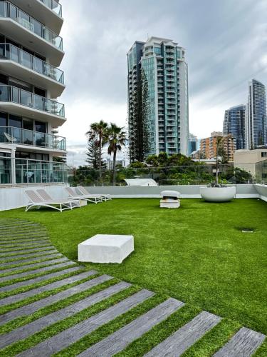 a grassy area with benches and buildings at Core beachfront 2 Bedrooms Apartment by Gold Coast Premium in Gold Coast
