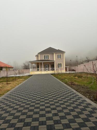 a house with a brick road in front of it at JLYN HOUSE in İsmayıllı