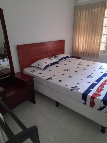 a bedroom with a bed and a chair in it at Palm Grove in Kalutara
