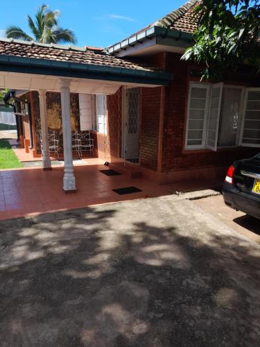 a house with a car parked in front of it at Palm Grove in Kalutara