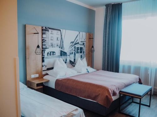 a hotel room with two beds and a window at Levy's Rooms & Breakfast in Salzburg