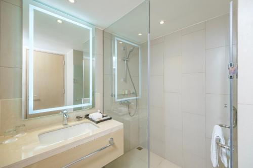 a bathroom with a sink and a shower at Seda Manila Bay in Manila