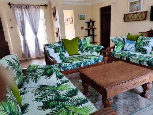 a living room with couches and a coffee table at Makao Nafuu Aprtments Malindi in Malindi