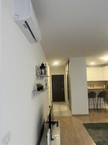 a white room with a kitchen and a living room at Apartment Urban by Heez in Tuzla