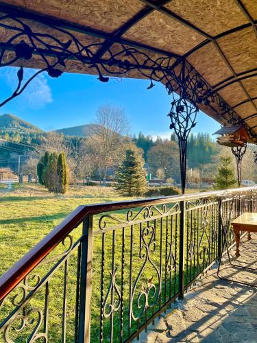 a balcony with a view of a field at Садиба Карпат in Verkhovyna