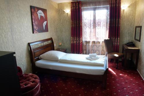 a bedroom with a bed and a window at Hotel Krone in Friesenheim