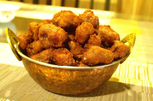 a bowl of fried food sitting on a table at Cozy Homestay & Cafe in Darjeeling