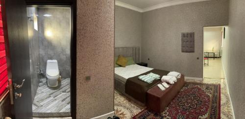 a small bedroom with a bed and a mirror at NRS Hotel in Baku