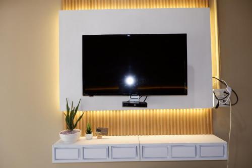 a flat screen tv hanging on a wall at มาชิลล์ รีสอร์ท สังขละบุรี in Sangkhla Buri