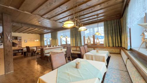 a restaurant with tables and chairs in a room at Alte Schmiede in Leutasch