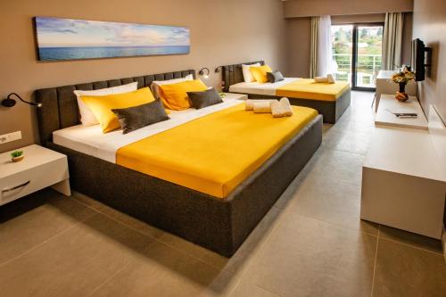 a large bedroom with a large bed with yellow sheets at First Joy Hotel in Trabzon