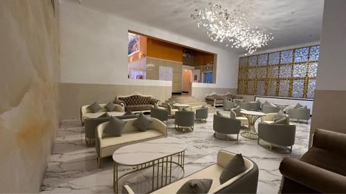 a lobby with couches and tables and chairs at Magnificent International Hotel in Shanghai