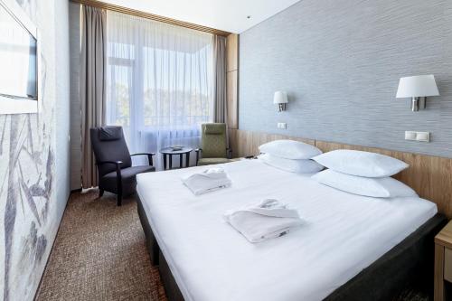 Postel nebo postele na pokoji v ubytování SPA VILNIUS Druskininkai