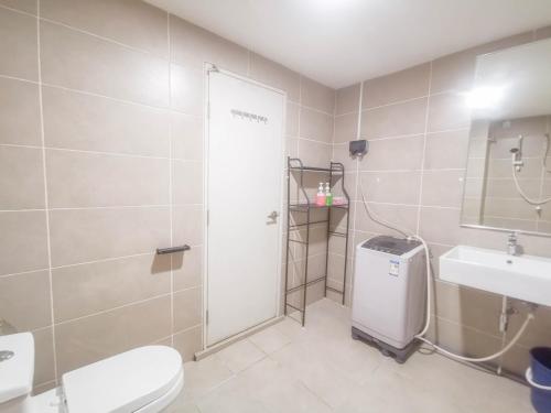 a bathroom with a shower and a toilet and a sink at D' Sara Sentral Suites by Manhattan Group in Sungai Buluh