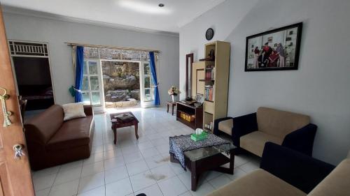 a living room with a couch and a table at Kluwih House in Godean