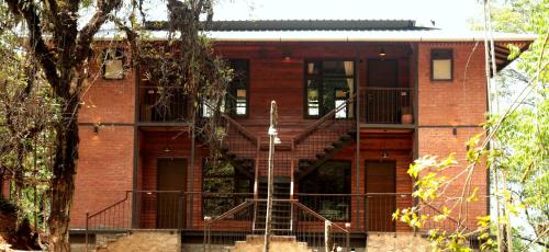 a brick building with a staircase in front of it at Red Panda Jungle Camp - A Unit of Davinchi Homes Pvt Ltd in Gyalzing