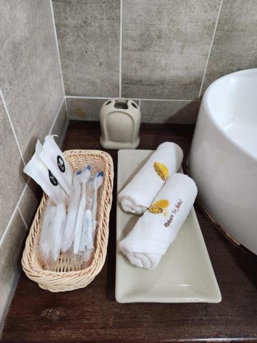 a bathroom with two baskets of towels and a sink at Uptown Eco Hotel in Kuala Terengganu