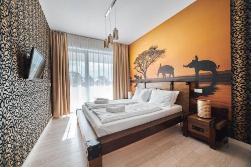 a bedroom with a bed and a large window at Apartament B225 - Dune Beach Resort in Mielno