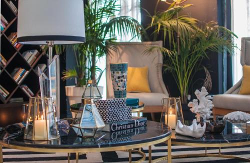 a living room with a table with a lamp and plants at Brown Beach House Tel-Aviv, a member of Brown Hotels in Tel Aviv